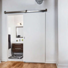 Load image into Gallery viewer, Box Rail Barn Door hardware installed on a white door in a bathroom area
